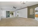 Spacious living room with carpet flooring, neutral walls, and sliding glass doors leading to the outdoors at 3309 Raleigh Dr, Winter Haven, FL 33884