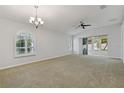 Spacious living room with carpet flooring, neutral walls, and sliding glass doors leading to the outdoors at 3309 Raleigh Dr, Winter Haven, FL 33884