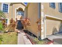 Front entrance with walkway, landscaping, and two-car garage at 42 Bolton Ct, Kissimmee, FL 34758