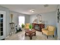 Cozy living room with two armchairs, a coffee table, and fireplace at 42 Bolton Ct, Kissimmee, FL 34758