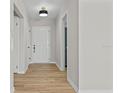 Bright entryway with light wood flooring and neutral walls at 501 Arneson Ave, Auburndale, FL 33823