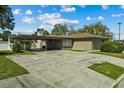 Front view of a ranch home with carport and mature landscaping at 501 Arneson Ave, Auburndale, FL 33823