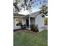 Charming house with gray siding, a covered porch, and landscaping at 1082 Sunshine Sw Way, Winter Haven, FL 33880