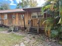 Wooden home with steps and a palm tree nearby at 1322 Shady Cove W Rd, Haines City, FL 33844