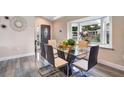 Bright dining room with glass table and bay window at 1591 Forest Hills Ln, Haines City, FL 33844