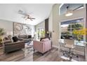 Spacious living room with sectional sofa, large window, and hardwood floors at 1591 Forest Hills Ln, Haines City, FL 33844