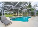 Inviting freeform pool with spa and screened enclosure at 2060 Hemingway Ave, Haines City, FL 33844