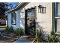 Modern front door with a stylish doormat, welcoming guests into the home at 315 Lauderdale Ct, Kissimmee, FL 34759