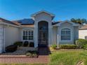 House exterior featuring a covered entryway and landscaped yard at 5340 Nicklaus Dr, Winter Haven, FL 33884