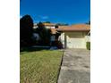 Inviting exterior of a condo with a well-maintained lawn and attached garage at 940 Fenton Ln # 6, Lakeland, FL 33809