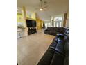 Open living area with a large sectional sofa and flat-screen TV at 1072 Old Cutler Rd, Lake Wales, FL 33898