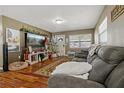 Spacious living room with hardwood floors, comfy sofas, and a Christmas tree at 128 Hawthorne Rd, Winter Haven, FL 33884