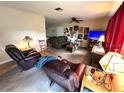 Cozy living room with plush seating, decorative lamps, and artwork displayed on the wall at 128 Stevenson Rd, Winter Haven, FL 33884