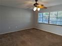 Spacious bedroom with neutral walls, carpeting, and ceiling fan at 16 Kendra Ct # 16, Winter Haven, FL 33880