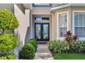 Double front doors with glass inserts and walkway at 1828 Rocky Pointe Dr, Lakeland, FL 33813