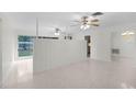 Open living space with a partial wall and ceiling fans at 1891 18Th Nw St, Winter Haven, FL 33881