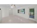 Bright living room featuring terrazzo floors and large windows at 1891 18Th Nw St, Winter Haven, FL 33881