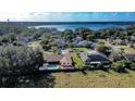 An aerial view showcasing the property, pool, and proximity to a nearby lake at 218 College Grove Ne Cir, Winter Haven, FL 33881