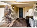 Inviting front entryway with a stone accent wall and a covered walkway at 218 College Grove Ne Cir, Winter Haven, FL 33881