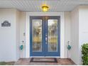 Double front doors with glass panels and decorative accents at 4210 Old Colony Rd, Mulberry, FL 33860