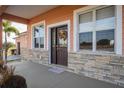 Inviting front entrance with stonework and a decorative wreath at 8243 Alturas Rd, Bartow, FL 33830