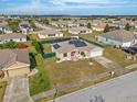 Bird's-eye view of a house with solar panels and a fenced backyard in a residential neighborhood at 117 Dinner Lake Ave, Lake Wales, FL 33859