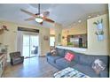 Open living area with gray couch and view of kitchen at 1490 Meadows Pond Dr, Bartow, FL 33830