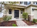 Inviting front entrance with a dark door, stone accents, and landscaping at 2002 Honeybell Ave, Haines City, FL 33844