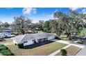 Single story home with large yard and driveway at 203 E Orange St, Davenport, FL 33837