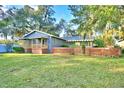 Charming gray house with a spacious lawn and mature trees at 2036 Lake Ariana Blvd, Auburndale, FL 33823