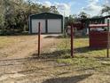 Green metal garage with double doors and a yard at 37 Hall St, Lake Wales, FL 33898