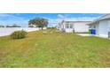Large grassy backyard with a privacy fence at 6308 Bayberry Ne Blvd, Winter Haven, FL 33881
