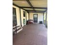 Covered back patio with a concrete floor and storage space at 6447 Hollyberry Ne Ln, Winter Haven, FL 33881