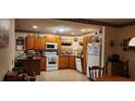 Galley kitchen with wood cabinets and a corner sink at 1190 S Goodman Rd, Champions Gate, FL 33896
