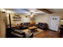 Comfortable living room featuring leather furniture and hardwood floors at 1190 S Goodman Rd, Champions Gate, FL 33896