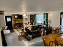 Bright living room featuring a stone fireplace and dining area at 3801 Us Highway 17 92 N, Davenport, FL 33837