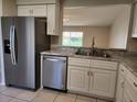 Modern kitchen with stainless steel appliances and white cabinets at 609 Estrada Ln, Kissimmee, FL 34758