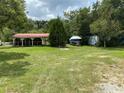Older mobile home with boat and additional mobile home in the yard at 607 Ronald Reagan Pkwy, Davenport, FL 33896