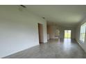 Spacious living room featuring neutral tile floors and plenty of natural light at 1049 Bergamot Dr, Bartow, FL 33830