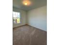Bright bedroom with carpeted floor and large window at 2137 Emma Ln, Lake Wales, FL 33859