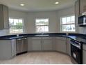 Spacious kitchen with stainless steel appliances and gray cabinets at 1218 Navel Rd, Bartow, FL 33830