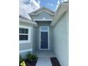 House entry with a blue door and walkway at 1218 Navel Rd, Bartow, FL 33830