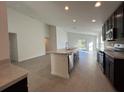 Open concept kitchen with island, stainless steel appliances, and ample counter space at 2169 Emma Ln, Lake Wales, FL 33859
