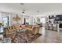 Spacious living room with L-shaped sofa and hardwood floors at 2720 Monticello Way, Kissimmee, FL 34741
