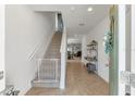 Bright entryway with staircase and view into living area at 2557 Shamrock St, Tavares, FL 32778