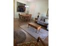Open concept living and dining area with hardwood floors at 3001 Calabria Ave, Davenport, FL 33897