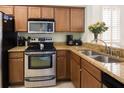 Modern kitchen with stainless steel appliances and granite countertops at 3001 Calabria Ave, Davenport, FL 33897