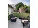 Back patio with wicker chairs and a view of a storage shed at 2103 Pimlico St, Orlando, FL 32822
