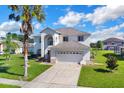 Two-story house with a palm tree and driveway at 4431 Canopy Ct, Kissimmee, FL 34758