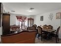 Living and dining area with leather furniture and hardwood floors at 7878 Tanbier Dr, Orlando, FL 32818